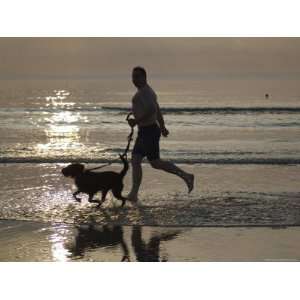  Silhouette of Man Running with Dog on Beach, Sunset, Romo 