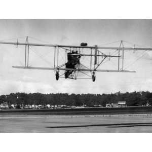  The Curtiss Pusher Type Biplane Shown in Flight over a 