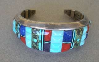  silver bracelet cuff with inlays of carved turquoise, coral, lapis