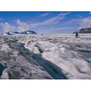 Bikers Travel Across the Rough Terrain and Melt Ice of Southern Alaska 