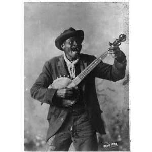  c1897,Happy John,Negro man standing and playing a banjo 
